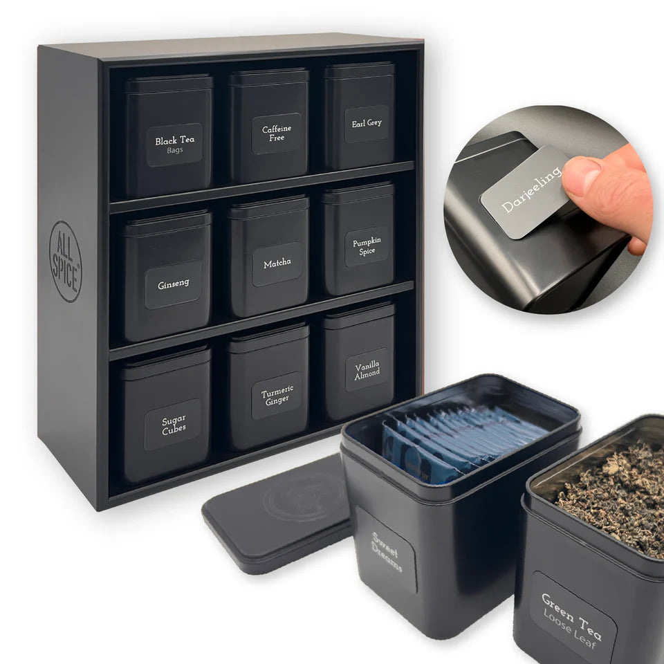 Set of black tea tins with labels in a black wood  organizer, including a close-up of a label being applied.