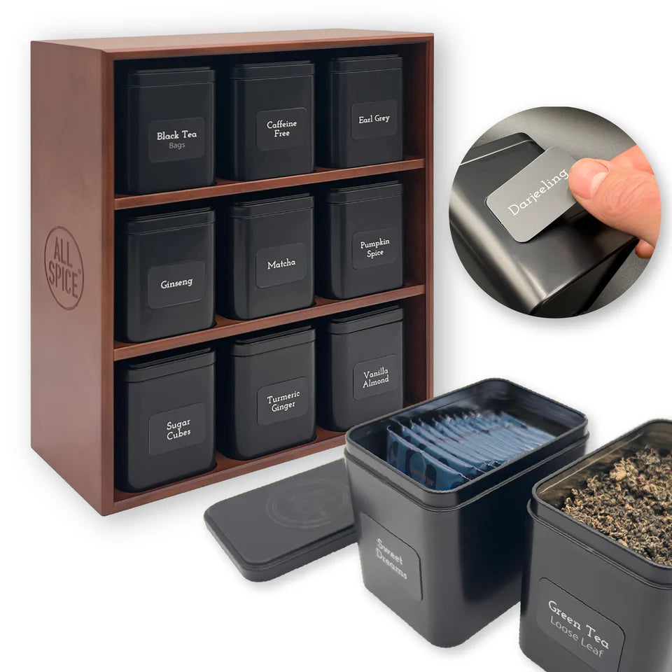 Set of black tea tins with labels in a walnut stain wood  organizer, including a close-up of a label being applied.