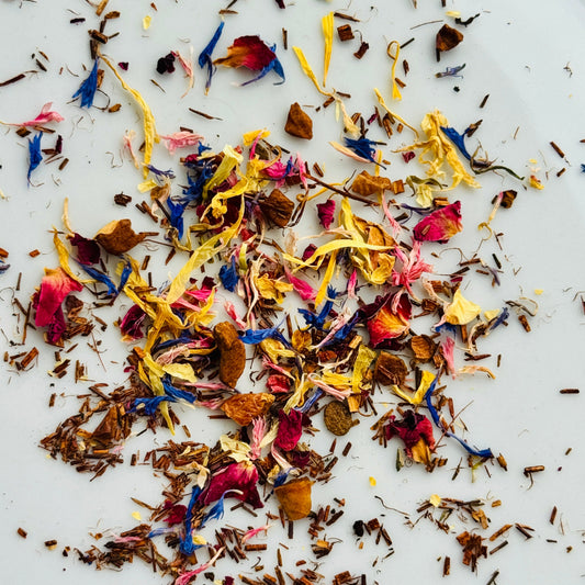 Rooibos and black tea with flowers on white background