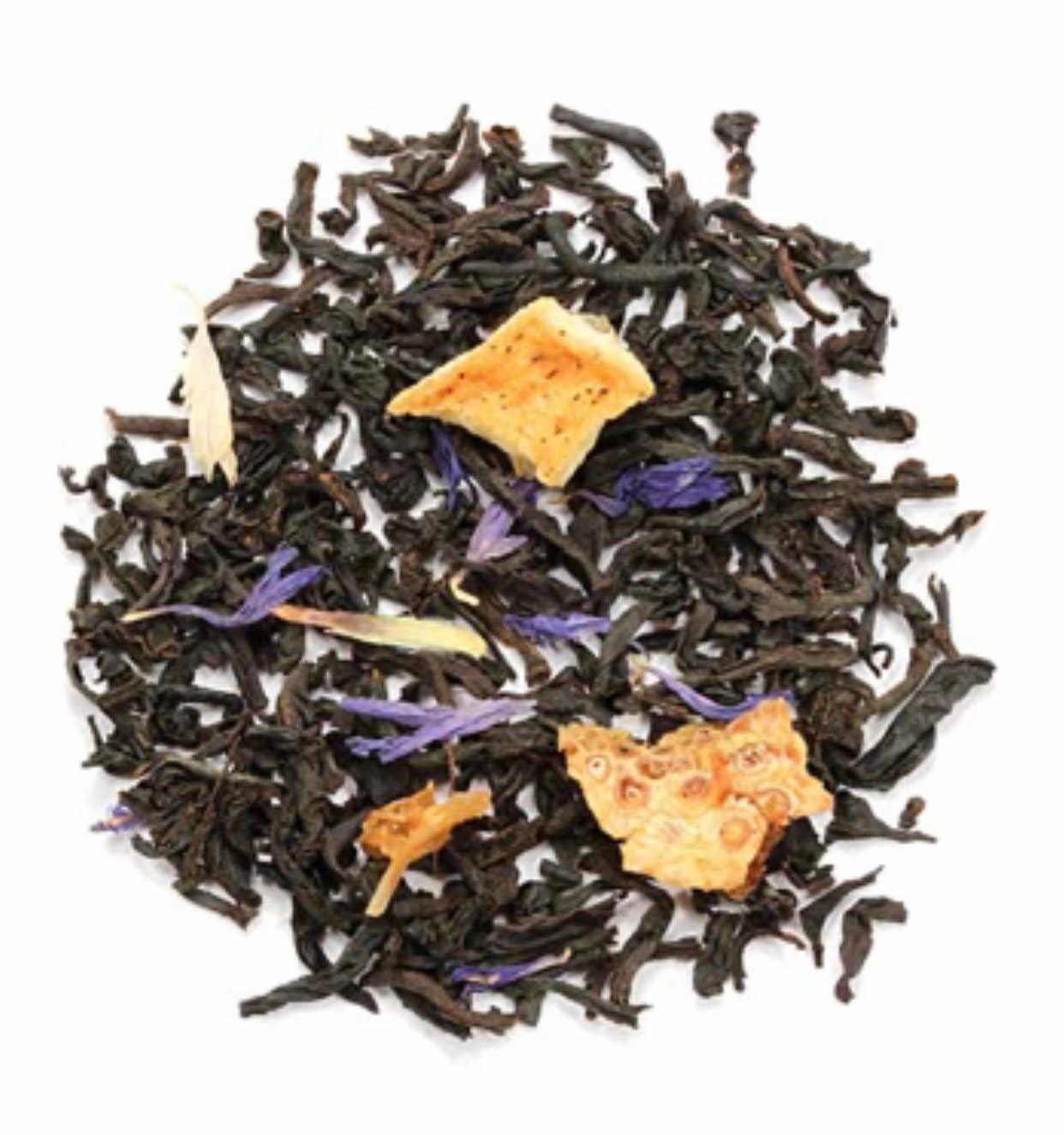 Black tea leaves with orange and purple flowers on a white background